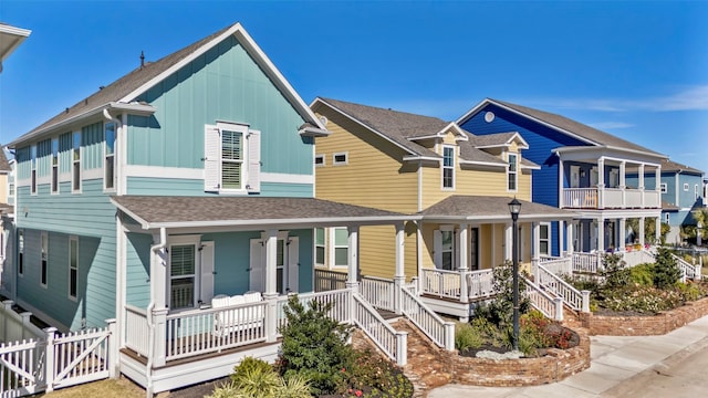 4 Caravelle Ct, Galveston, TX 77554 - view of front of home featuring covered porch, board and batten siding, and roof with shingles