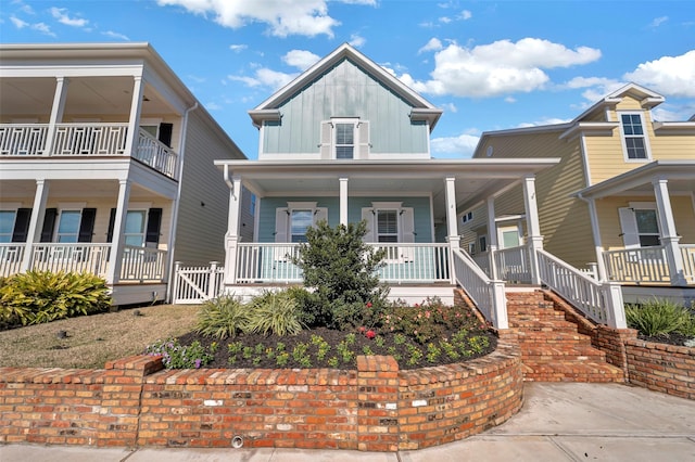 4 Caravelle Ct, Galveston, TX 77554 - view of front facade with covered porch, board and batten siding, and a gate