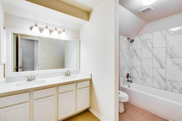bathroom with toilet, a sink, double vanity, and visible vents