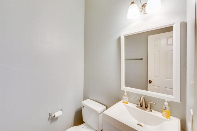 bathroom featuring toilet and vanity