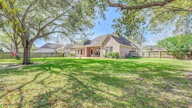 4210 Wentworth Dr, Fulshear, TX 77441 - rear view of house featuring brick siding, central AC, and a patio area