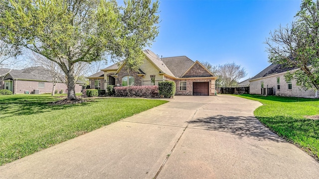 4210 Wentworth Dr, Fulshear, TX 77441 - view of front of house with driveway, an attached garage, and stone siding