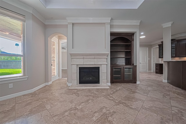 4210 Wentworth Dr, Fulshear, TX 77441 - unfurnished living room featuring a high end fireplace, ornamental molding, baseboards, arched walkways, and recessed lighting