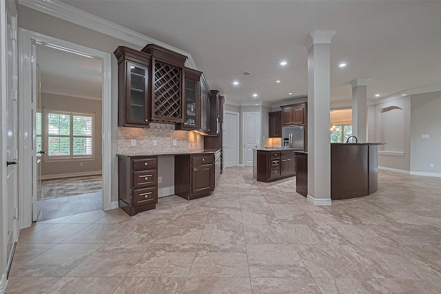 4210 Wentworth Dr, Fulshear, TX 77441 - kitchen featuring stainless steel fridge with ice dispenser, ornamental molding, dark brown cabinetry, tasteful backsplash, and glass insert cabinets