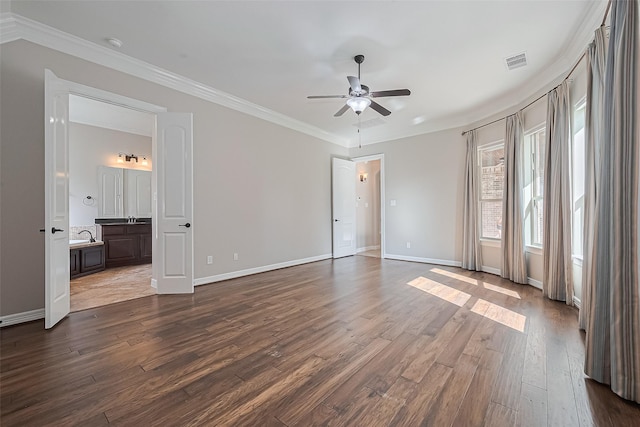 4210 Wentworth Dr, Fulshear, TX 77441 - unfurnished bedroom with dark wood-style flooring, crown molding, baseboards, ensuite bath, and a sink