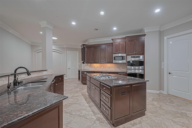 4210 Wentworth Dr, Fulshear, TX 77441 - kitchen featuring a sink, appliances with stainless steel finishes, a kitchen island, ornamental molding, and decorative backsplash