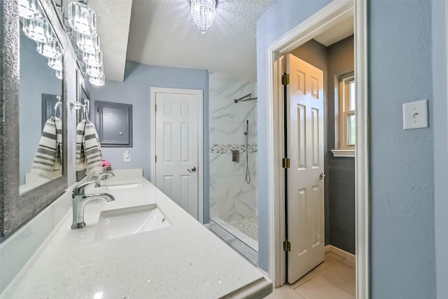9610 Twin Oaks Dr, Manvel, TX 77578 - full bathroom featuring a marble finish shower, a sink, a textured ceiling, and double vanity