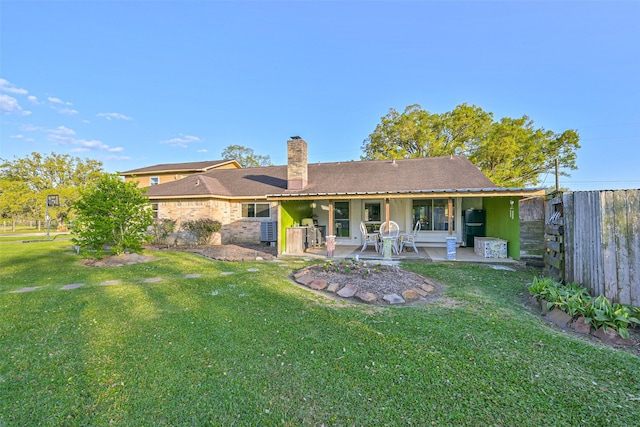 9610 Twin Oaks Dr, Manvel, TX 77578 - back of house featuring a yard, a chimney, a patio, and fence