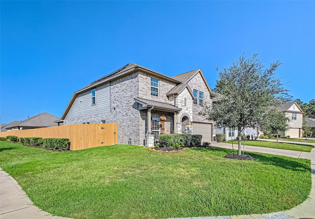 view of front of house featuring fence, a front lawn, stone siding, a garage, and concrete driveway