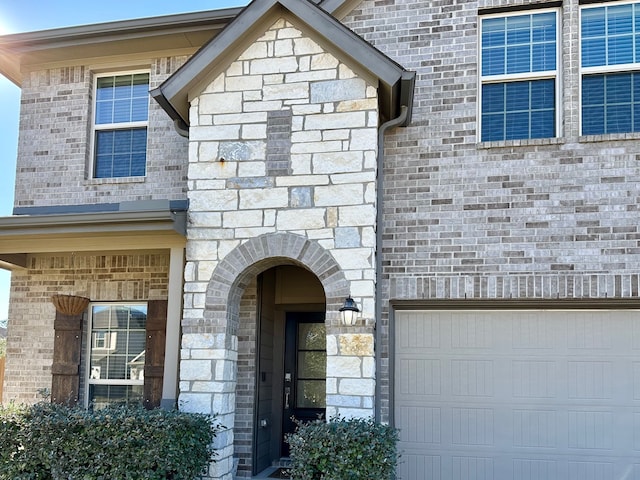 doorway to property with a garage