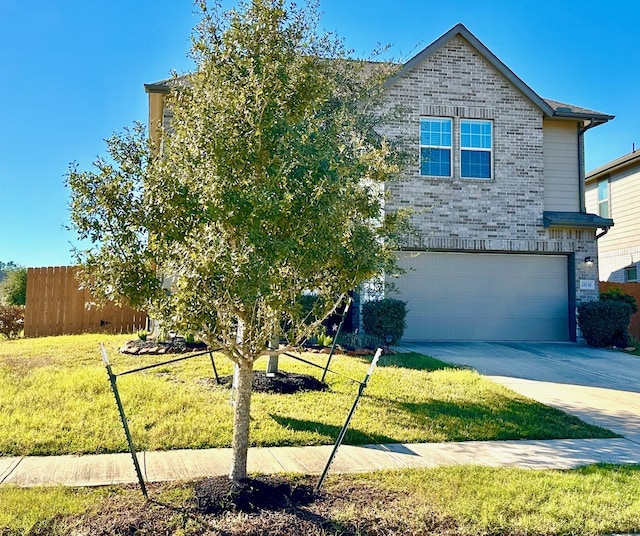 view of front facade with a garage, a front lawn, fence, brick siding, and driveway