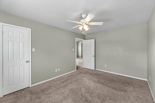 4810 Legends Bay Dr, Baytown, TX 77523 - unfurnished bedroom with carpet flooring, a ceiling fan, and baseboards