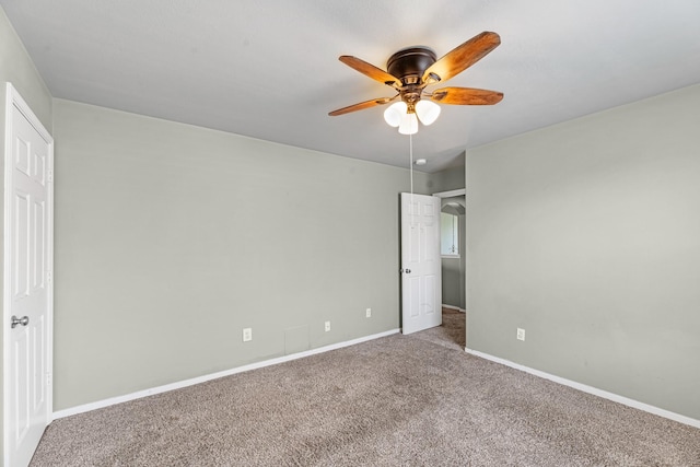 4810 Legends Bay Dr, Baytown, TX 77523 - unfurnished bedroom with baseboards, carpet flooring, and a ceiling fan