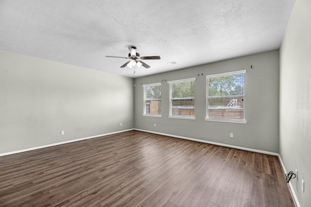 4810 Legends Bay Dr, Baytown, TX 77523 - empty room featuring ceiling fan, a textured ceiling, baseboards, visible vents, and dark wood-style floors