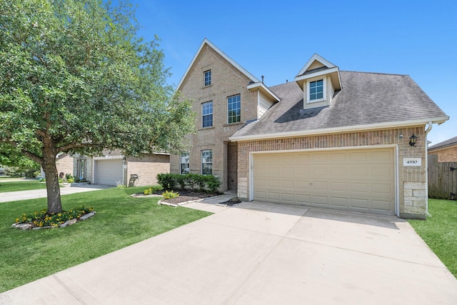 4810 Legends Bay Dr, Baytown, TX 77523 - view of front facade featuring brick siding, a front lawn, and concrete driveway