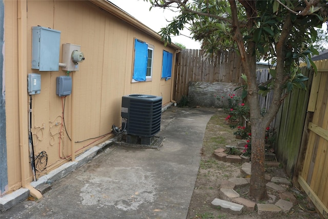 view of home's exterior with a patio, central AC unit, and a fenced backyard