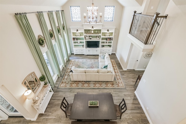 20207 Desert Foal Dr, Tomball, TX 77377 - living room with a high ceiling, a chandelier, baseboards, and wood finished floors
