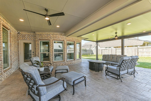 20207 Desert Foal Dr, Tomball, TX 77377 - view of patio / terrace with fence, a ceiling fan, and an outdoor living space with a fire pit