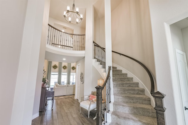 20207 Desert Foal Dr, Tomball, TX 77377 - staircase with a chandelier, wood finished floors, and a high ceiling