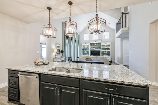 20207 Desert Foal Dr, Tomball, TX 77377 - kitchen with dark cabinets, dishwasher, a sink, a chandelier, and open floor plan