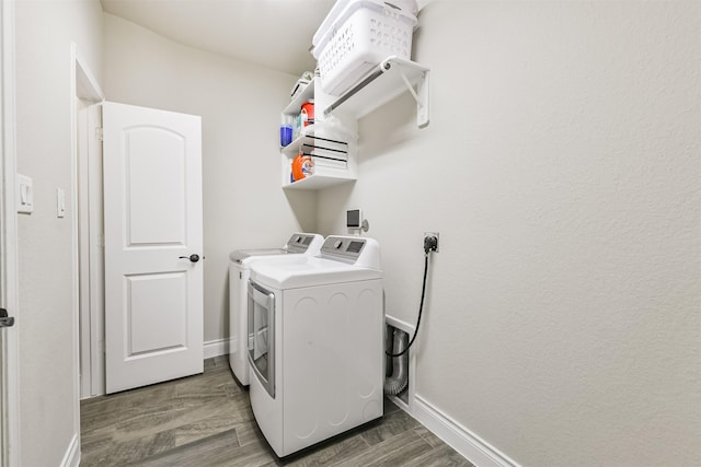 20207 Desert Foal Dr, Tomball, TX 77377 - laundry room with washing machine and clothes dryer, baseboards, and wood finished floors