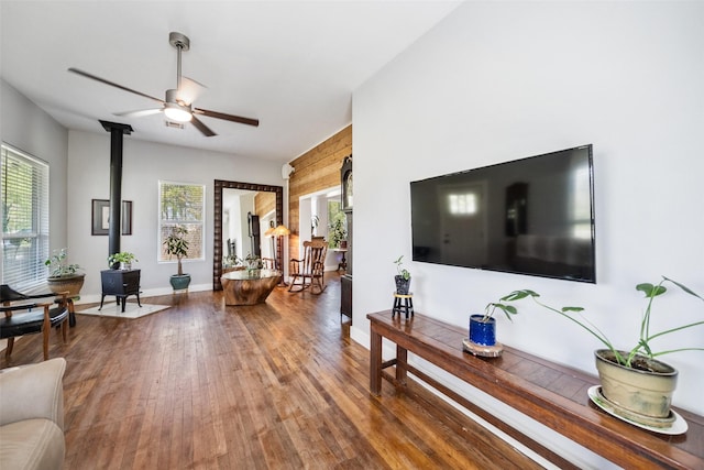 275 Pashun Ln, New Waverly, TX 77358 - living area featuring ceiling fan, baseboards, wood finished floors, and a wood stove