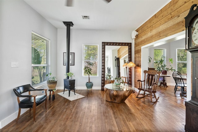 275 Pashun Ln, New Waverly, TX 77358 - living area featuring plenty of natural light, wood finished floors, wood walls, and a wood stove