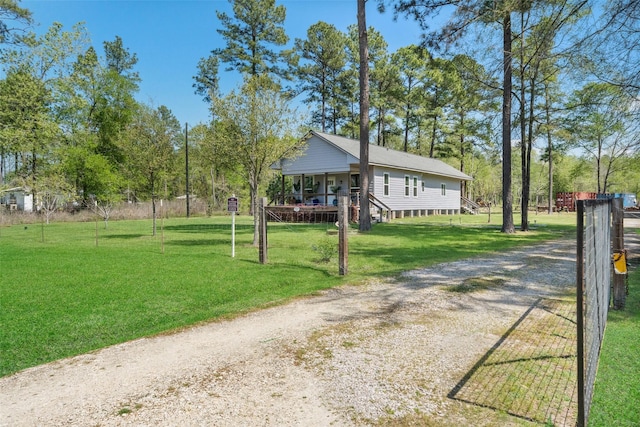275 Pashun Ln, New Waverly, TX 77358 - view of front of property featuring covered porch, dirt driveway, a front yard, and fence