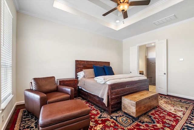 bedroom with crown molding, baseboards, a raised ceiling, visible vents, and wood finished floors