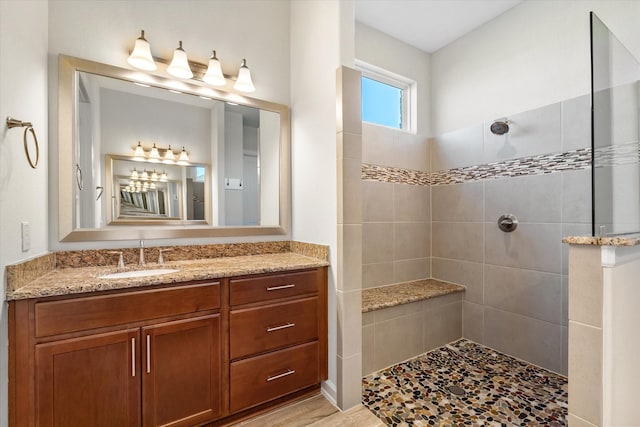 bathroom with a walk in shower and vanity