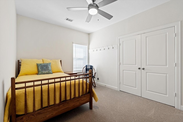carpeted bedroom with baseboards, visible vents, a closet, and a ceiling fan