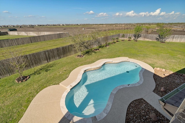 view of swimming pool with a fenced backyard and a yard