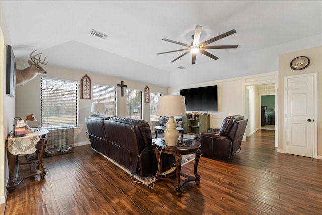 living area with hardwood / wood-style floors, baseboards, visible vents, and a ceiling fan