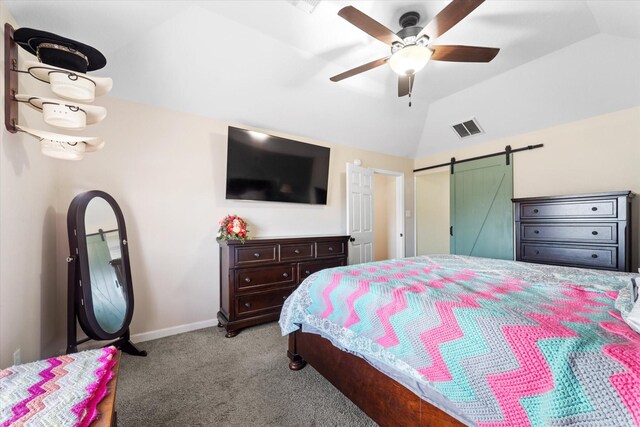 carpeted bedroom with lofted ceiling, baseboards, a barn door, ceiling fan, and visible vents