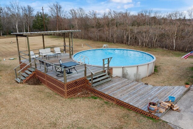 pool featuring a deck and a yard