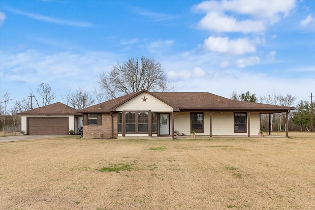 ranch-style house with an outdoor structure, concrete driveway, roof with shingles, a front yard, and a garage