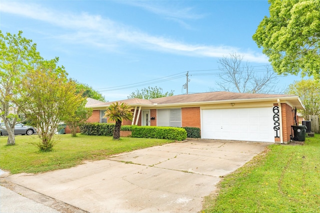 ranch-style house featuring driveway, central AC unit, a front yard, brick siding, and a garage