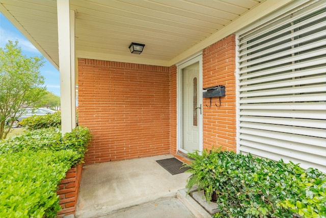 entrance to property with brick siding