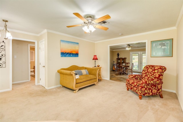 living room with a ceiling fan, carpet floors, ornamental molding, and baseboards