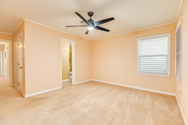 unfurnished room featuring light colored carpet, ceiling fan, ornamental molding, and baseboards