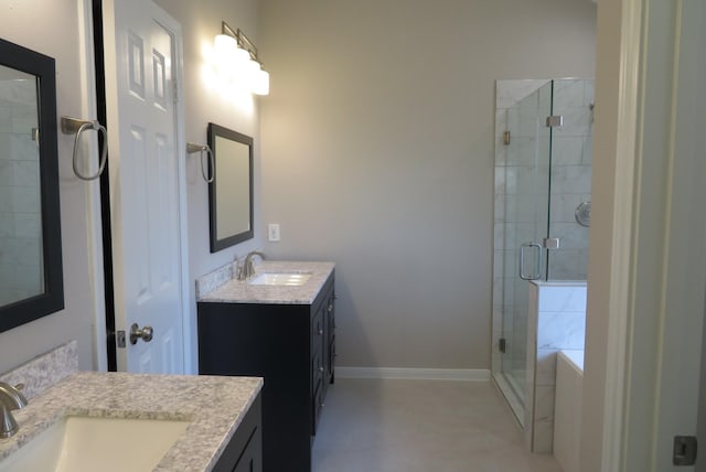 1606 Caslyn Dr, Rosenberg, TX 77471 - full bath featuring two vanities, a shower stall, a garden tub, and baseboards