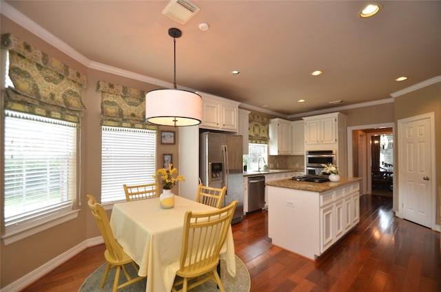 4242 Noble Oak Trl, Houston, TX 77059 - kitchen featuring stainless steel appliances, a kitchen island, a sink, white cabinetry, and decorative backsplash