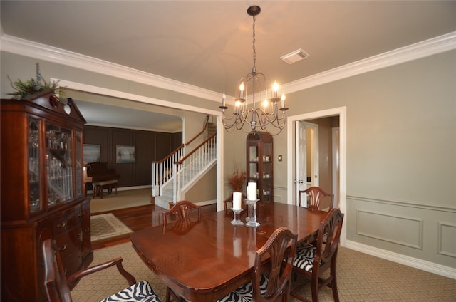 4242 Noble Oak Trl, Houston, TX 77059 - dining room featuring a chandelier, a decorative wall, crown molding, stairway, and wainscoting