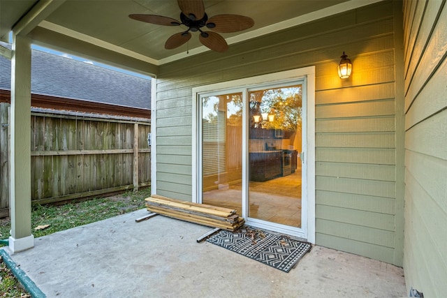 doorway to property with a patio, fence, and ceiling fan