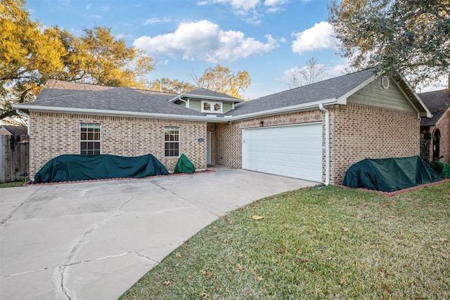 view of front facade with an attached garage, a shingled roof, concrete driveway, and a front yard