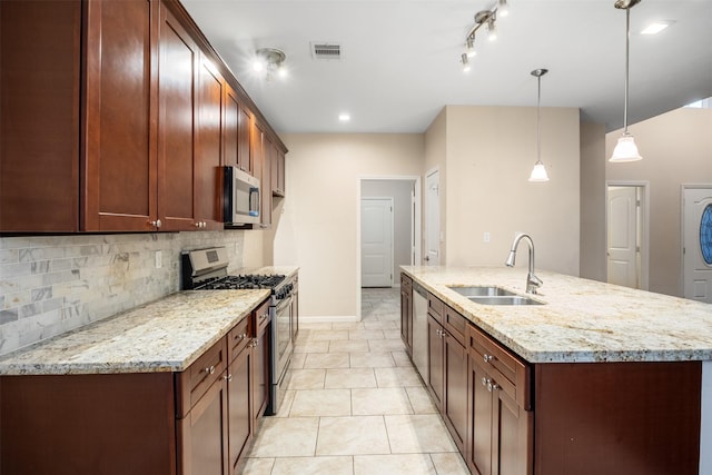 kitchen featuring tasteful backsplash, a sink, an island with sink, visible vents, and appliances with stainless steel finishes