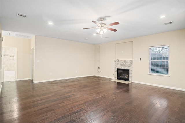 unfurnished living room featuring a fireplace with flush hearth, dark wood-style floors, ceiling fan, and visible vents