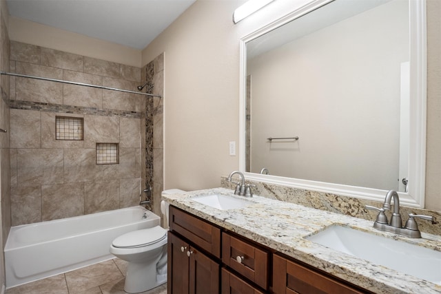 bathroom featuring toilet, a sink, shower / bathing tub combination, and tile patterned flooring