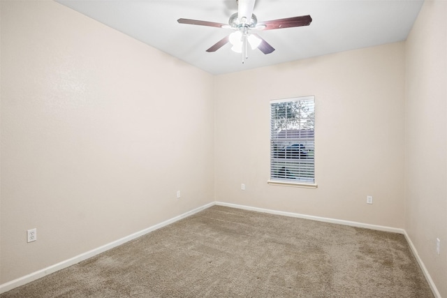 unfurnished room with baseboards, carpet flooring, and a ceiling fan