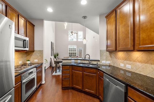 1222 Glenwood Canyon Ln, Houston, TX 77077 - kitchen featuring appliances with stainless steel finishes, a sink, dark wood-type flooring, brown cabinetry, and recessed lighting